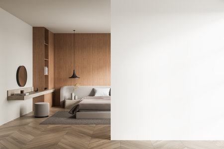 Minimalist bedroom featuring a wooden accent wall, contemporary furniture, and a large blank white wall. Neutral tones, mockup concept. 3D Rendering.の写真素材