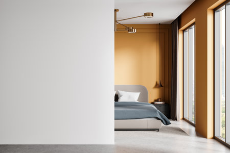 Minimalistic mockup of a clean white wall beside a modern bedroom with warm tones, soft bedding, and large windows, ideal for interior design concepts. 3D Rendering.の写真素材
