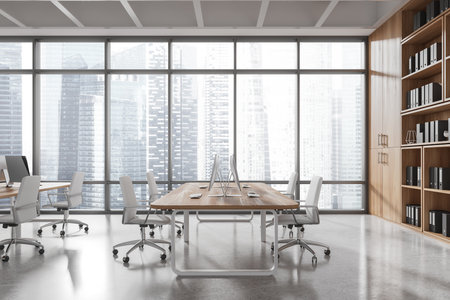 Modern office interior with wooden desks, chairs, shelves, and large windows overlooking city skyscrapers, 3D Rendering, concept of coworking spaceの写真素材