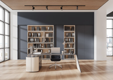 Workspace featuring a sleek desk, modern chair, and bookshelves with folders, set on a wooden floor, with a bright window-lit background. Office concept. 3D Rendering.の写真素材