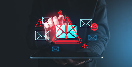 Hand interacting with red and blue spam email icons on a dark background, symbolizing digital security threats and email spamの写真素材