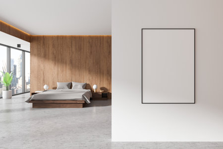 A blank poster mockup displayed on a white wall in a modern bedroom with wood paneling, minimalistic furniture, and a city view. 3D renderingの写真素材