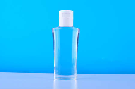A portable alcohol spray bottle  for protection against infections on white table
