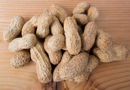 Salted peanuts.With natural wood background.