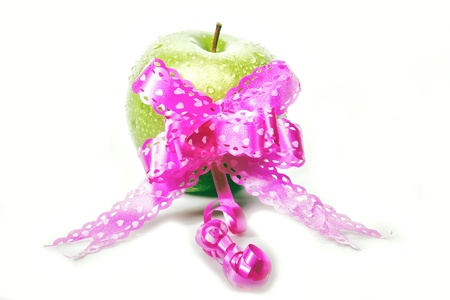 green apple with pink ribbon for valentine, white backgroundの写真素材
