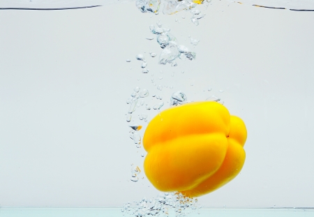 yellow paprika splashing,isolated white backgroundの写真素材