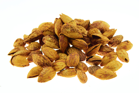 Almond in shell roast sugar isolated on white backgroundの写真素材