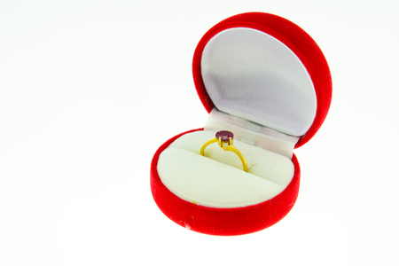 Gold ring with red gem in red box isolated on a whiteの写真素材