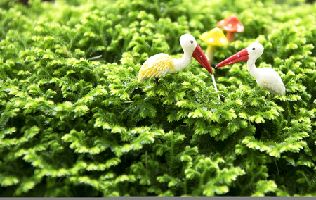 egret statue on green plantの写真素材