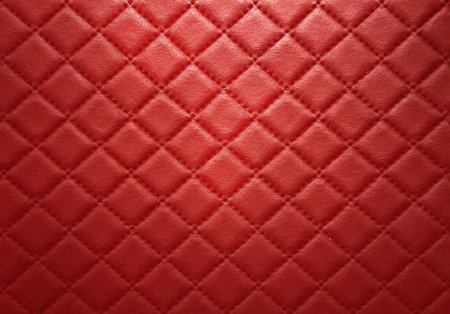 Red leather texture with seam backgroundの写真素材