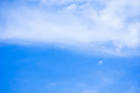 white fluffy clouds in the blue skyの写真素材