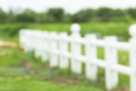 white fence in farm field. image is blurred and filteredの写真素材