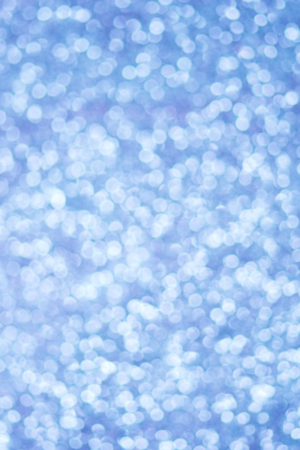Blue bokeh texture. Festive glitter background with defocused lightsの写真素材