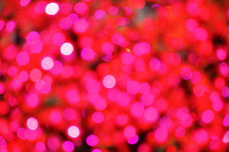 Red bokeh defocused lights background. Festive Christmas backgroundの写真素材