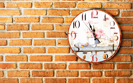 old clock on brick wall background