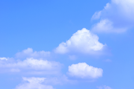 white fluffy clouds in the blue skyの写真素材