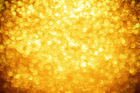 Gold bokeh texture. Festive glitter background with defocused lightsの写真素材