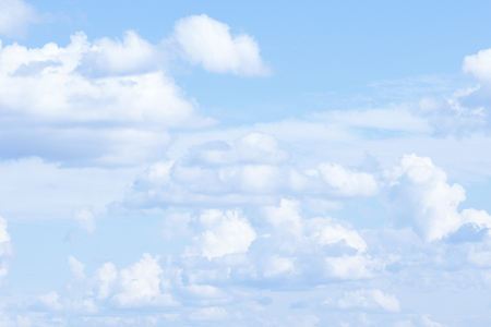 white fluffy clouds in the blue skyの写真素材