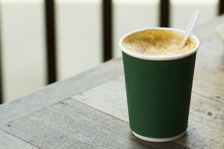 hot coffee in paper cup on wood textureの写真素材