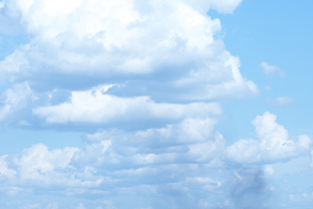 white fluffy clouds in the blue skyの写真素材