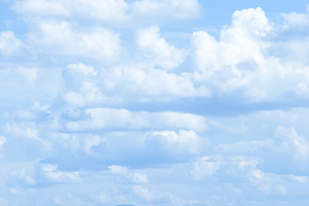 white fluffy clouds in the blue skyの写真素材