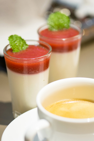 Hot coffee and strawberry mousse in glassの写真素材