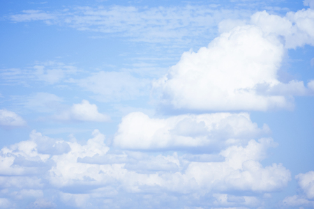 white fluffy clouds in the blue skyの写真素材