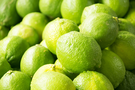 Fresh and green lemons backgroundの写真素材