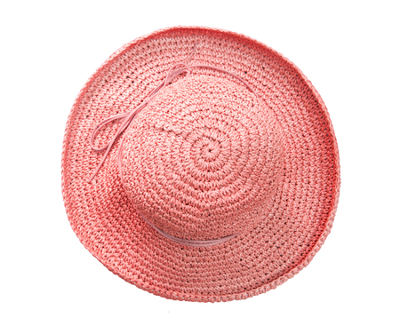 Red pretty straw hat with bow on white background. Beach hat top view isolatedの写真素材