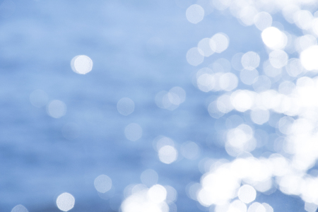 Reflection light on blue sea defocused abstract lights.の写真素材