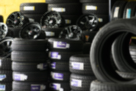 Blur image of shop and tire. Tyre showing for sell on shop.の写真素材