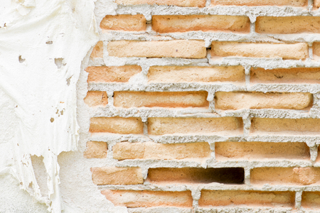 Layered wall erosion with bricks. Texture of an old brick wall.の写真素材