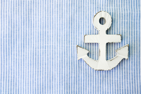 A white wood anchor on fabric for backgroundの写真素材
