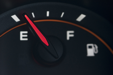 Close-up car dash board petrol meter on black background.の写真素材
