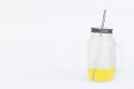 Fresh orange juice in the mason jar on white backgroundの写真素材