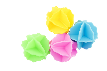 plastic balls for washing clothes in the washing machine on white background.の写真素材
