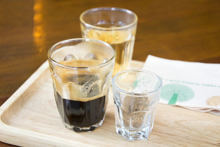 coffee in  glass on wooden backgroundの写真素材