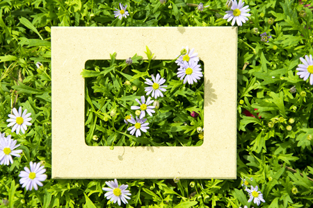 Creative layout made of purple flowers and leaves with frame. Top view. Nature conceptの写真素材