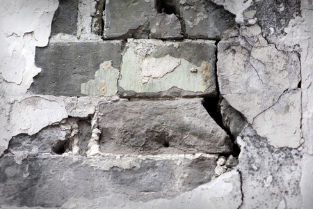 Layered wall erosion with bricks. Texture of an old brick wall.の写真素材