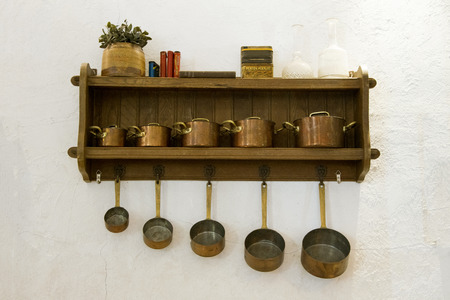 Set of Gold Vintage kitchen utensil hanging on white background.の写真素材