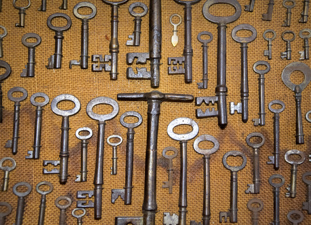 overhead of many different retro keys on brown sack fabric background concept.の写真素材