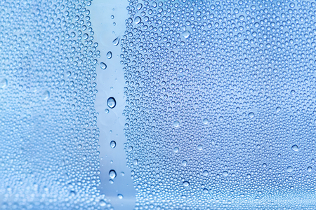 Water backgrounds with water drops. Blue water bubbles on window glass.の写真素材