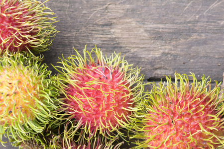 Fresh rambutan on wood backgroundの写真素材