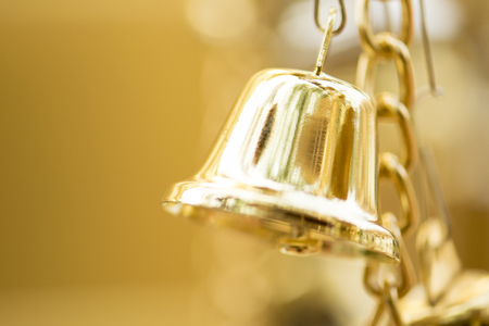 gold bells against defocused backgroundの写真素材