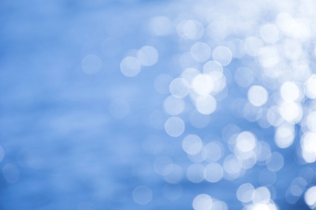 Reflection light on blue sea defocused abstract lights.の写真素材
