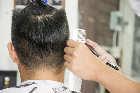 Haircut men Barbershop. Men's Hairdressers; barbers. Barber cuts the client machine for haircuts.の写真素材