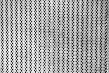 metal plate with many black dots texture backgroundの写真素材