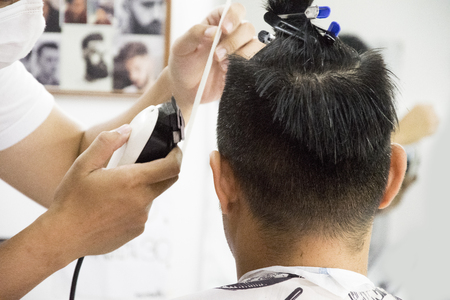 Haircut men Barbershop. Men's Hairdressers. barbers. Barber cuts the client machine for haircuts.の写真素材