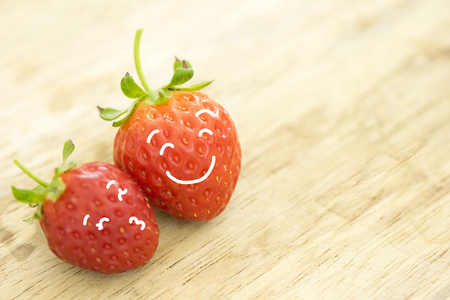 Love and happy concep. Painting on strawberry face smile.の写真素材