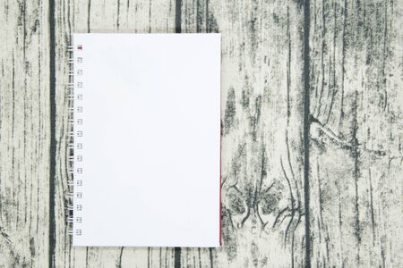 White notebook on  table wood background.の写真素材